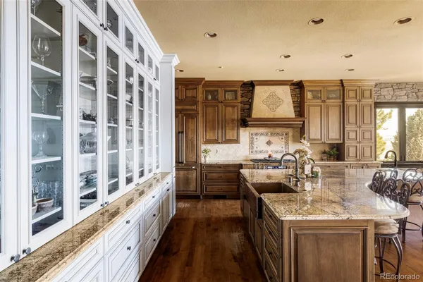 a kitchen with stainless steel appliances granite countertop a stove and a sink
