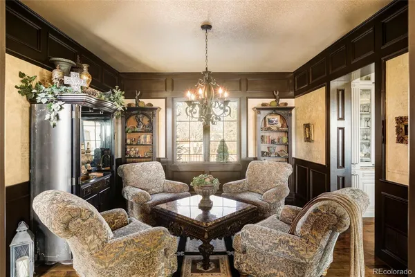 a living room with furniture and a chandelier