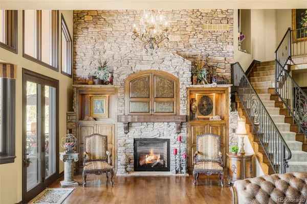 a living room with a fireplace and wooden floor