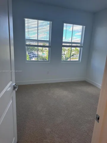 a living room with a large window and a table