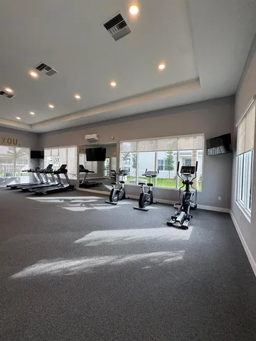 a living room with furniture a wooden floor and a large window