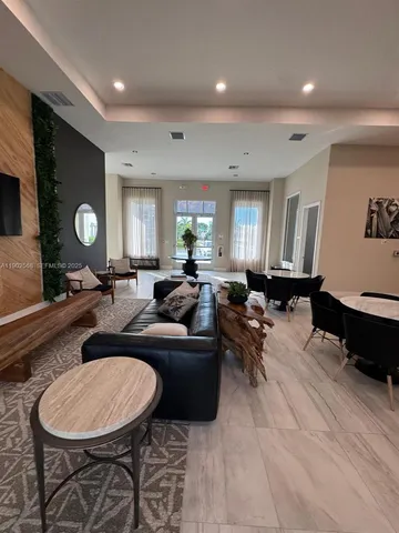 a front view of a house with yard and parking