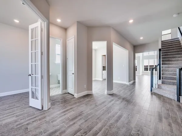 a view of a hallway with wooden floor