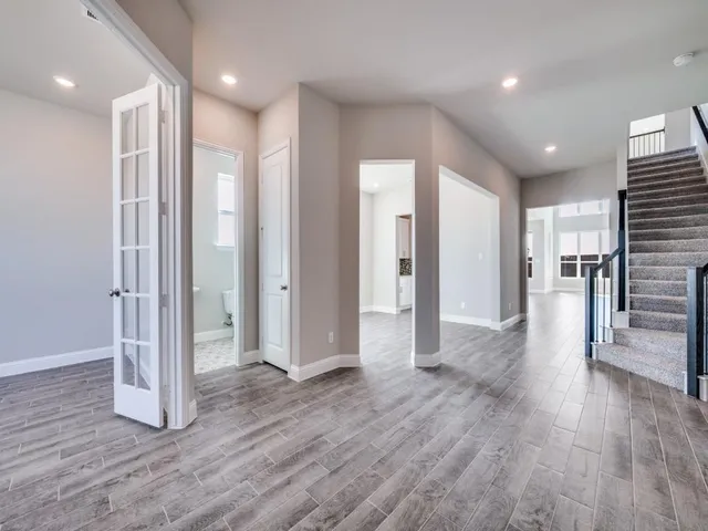 a view of a hallway with wooden floor