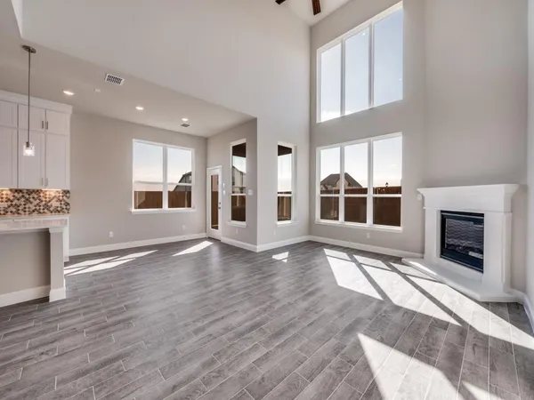 a view of empty room with wooden floor and fireplace