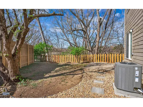 a view of a backyard with wooden fence