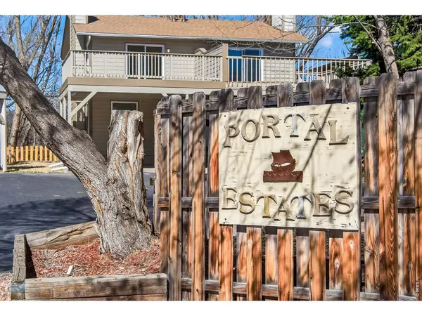 a view of wooden house with a fence