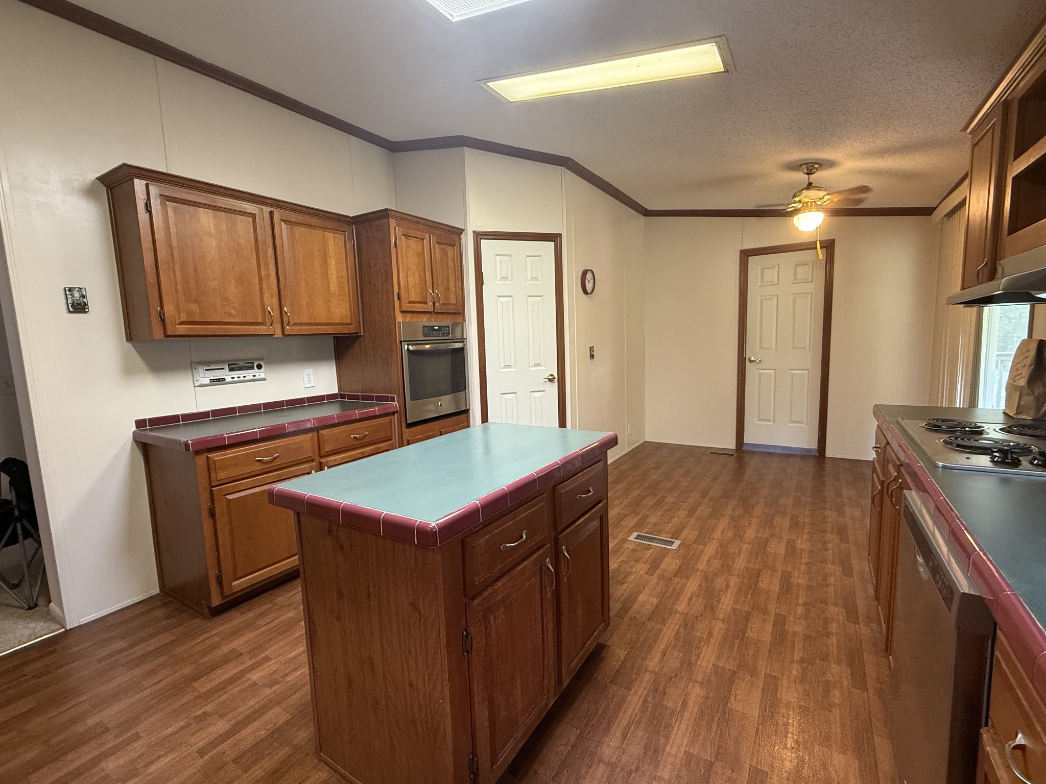 501 Post Road Michie, TN 38357 - Photo 11 of 21 a kitchen with kitchen island granite countertop wooden cabinets a sink and a stove
