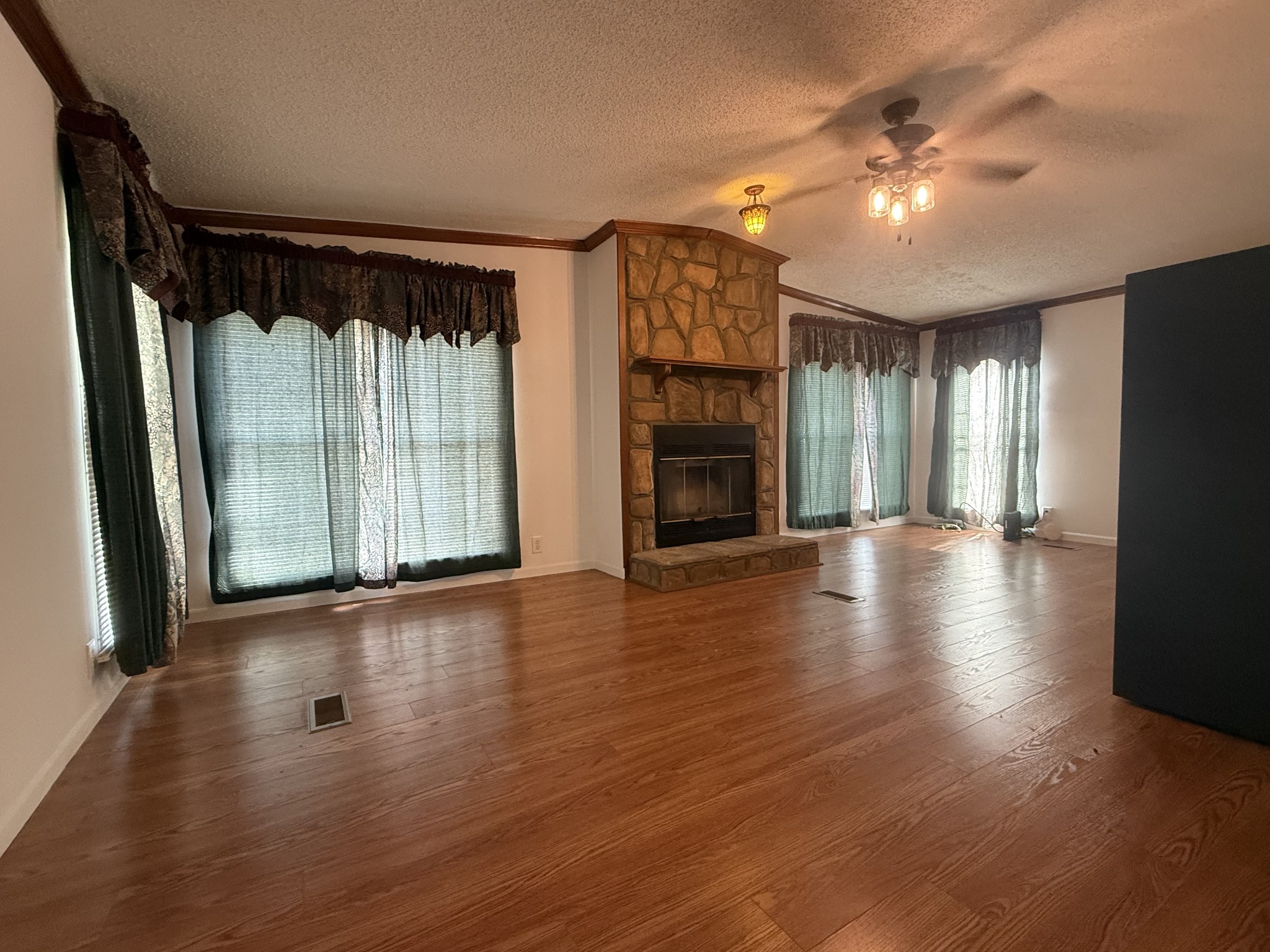 501 Post Road Michie, TN 38357 - Photo 15 of 21 an empty room with wooden floor and windows