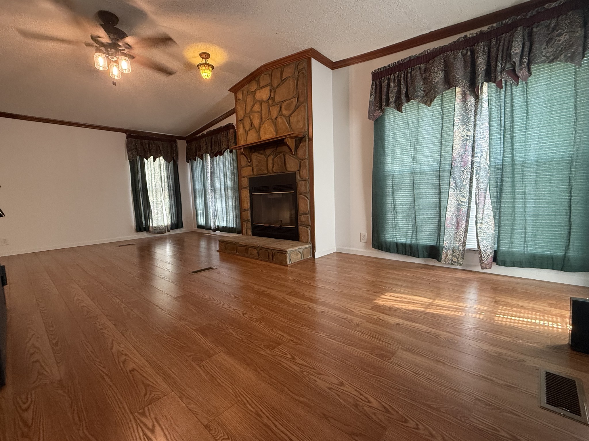 501 Post Road Michie, TN 38357 - Photo 16 of 21 a view of a big room with wooden floor fan and windows