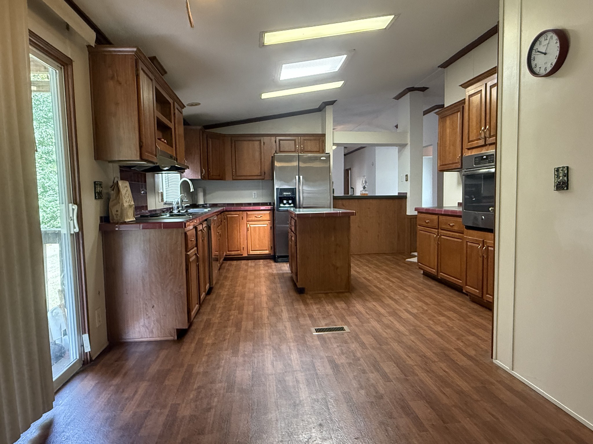 501 Post Road Michie, TN 38357 - Photo 10 of 21 a kitchen with stainless steel appliances granite countertop a refrigerator oven a sink dishwasher and wooden floor