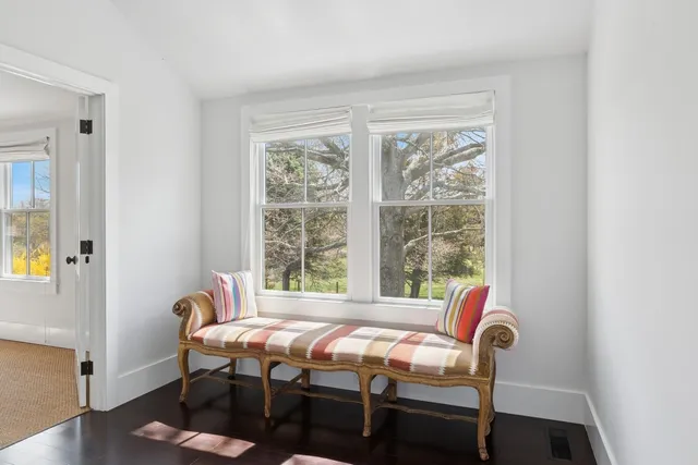 a bed sitting in a bedroom next to a window