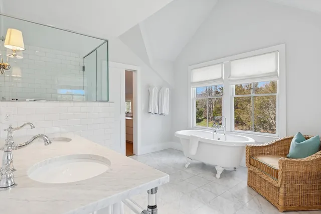 a spacious bathroom with a bathtub and a shower