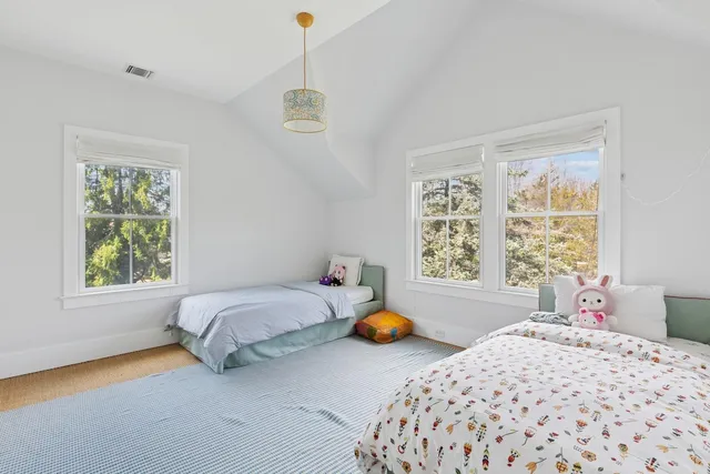 a view of a house with a backyard balcony and a large window