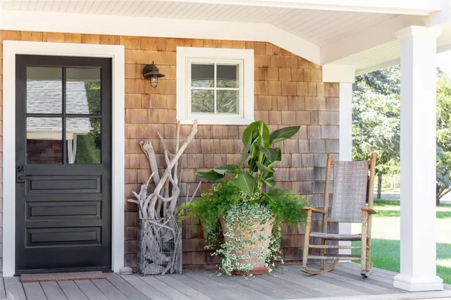 a front view of a house with a yard table and chairs
