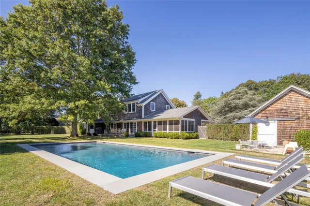 a front view of house with yard and outdoor seating