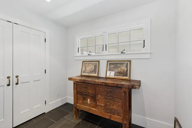 a kitchen with stainless steel appliances a stove a sink dishwasher a refrigerator and a fireplace with wooden floor