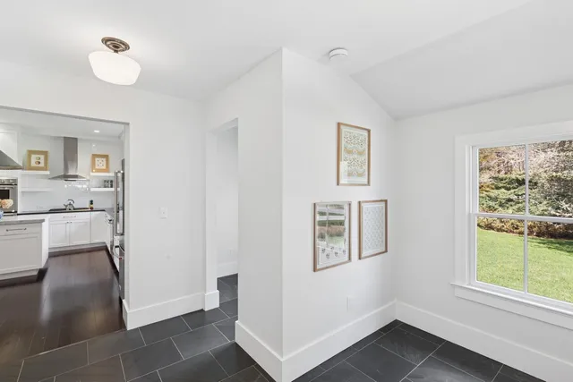 a kitchen with stainless steel appliances granite countertop a sink a stove and wooden floors