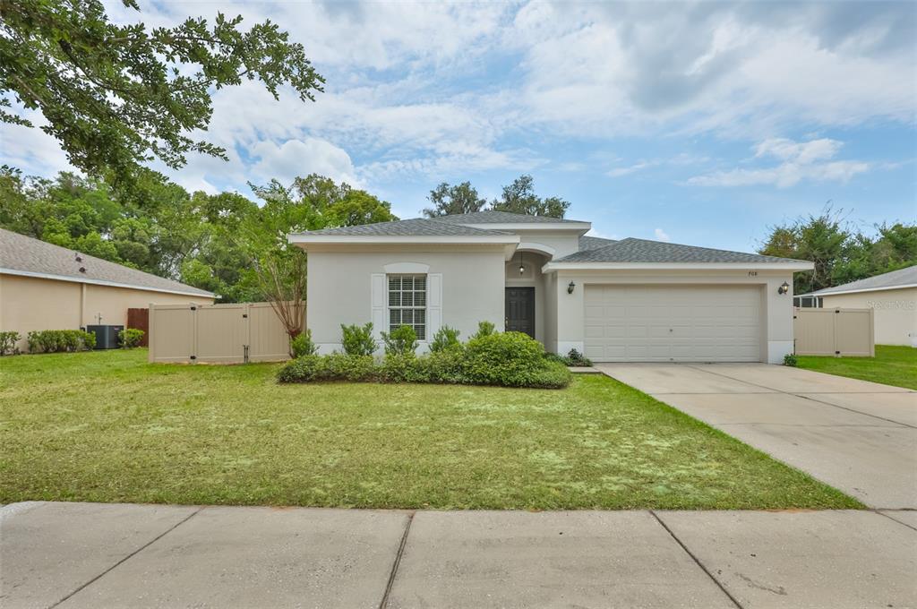 708 Coade Stone Drive Seffner, FL 33584 - Photo 39 of 48 a front view of house with yard and green space