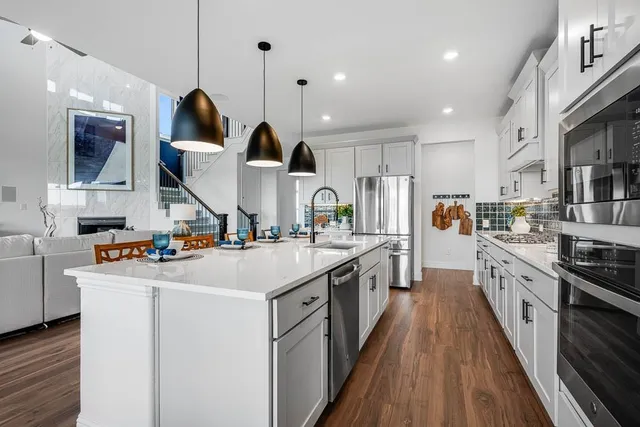 a dining room with furniture a chandelier and wooden floor
