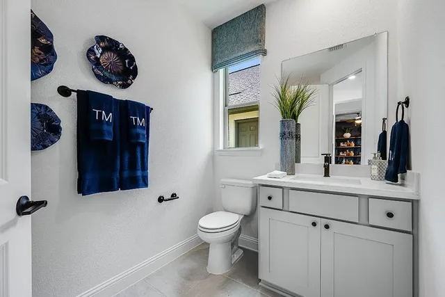 a living room with furniture a lamp and a large window