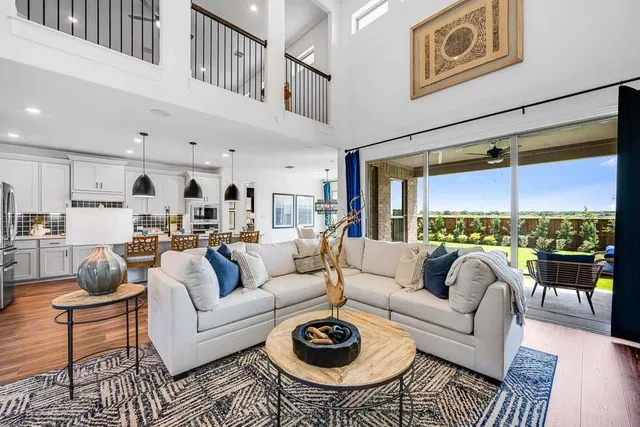 a view of a bedroom with wooden floor and windows
