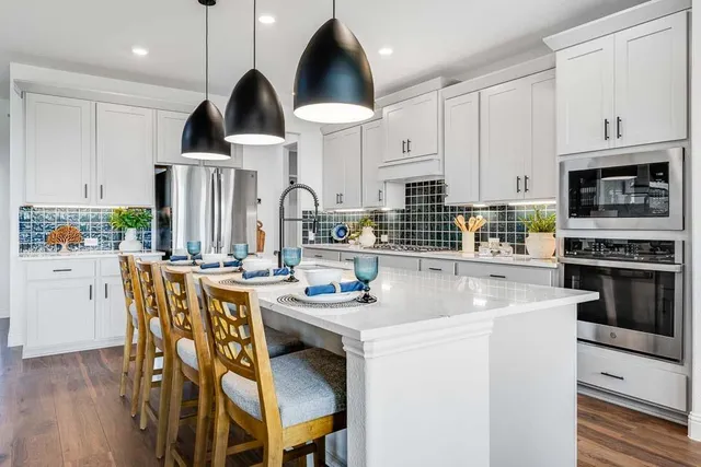 a living room with furniture kitchen view and a fireplace