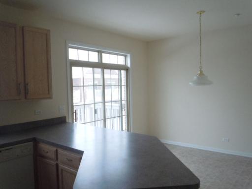 554 Prestwick Lane Wheeling, IL 60090 - Photo 5 of 16 a view of an empty room with wooden floor and a window