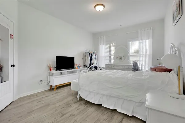 a bedroom with a bed and a flat screen tv