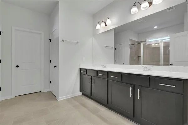 a bathroom with a double vanity sink and mirror