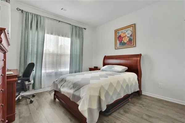 a large bed sitting in a bedroom next to a window
