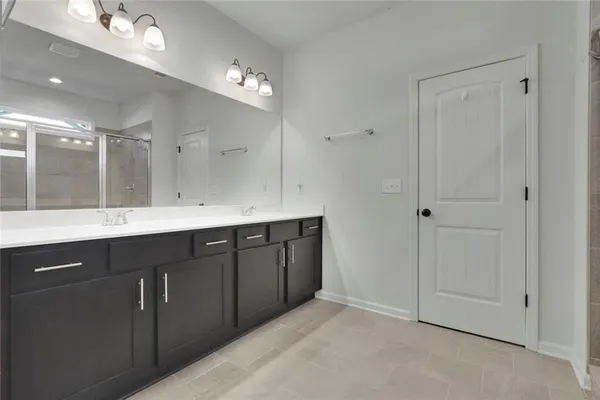 a bathroom with a double vanity sink and mirror