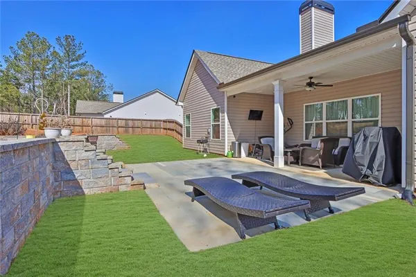 a view of a house with backyard porch and sitting area