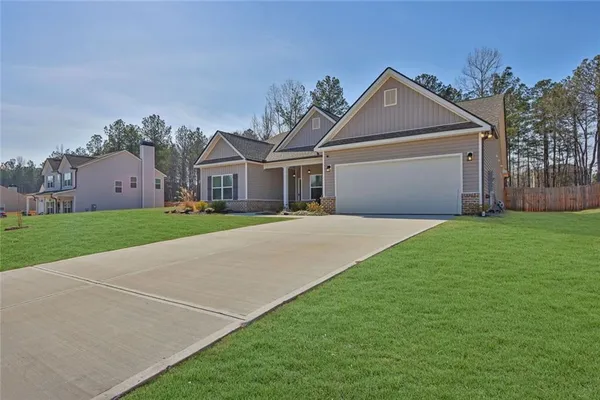 a front view of house with yard and green space