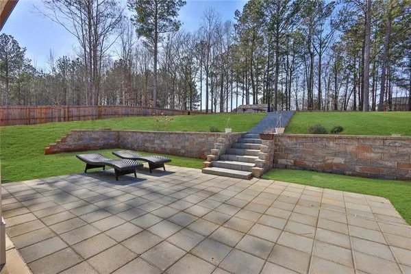 a yard with lots of green space and trees