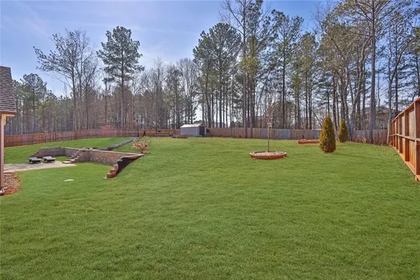 a view of a house with a yard and sitting area