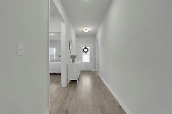a view of a hallway with wooden floor