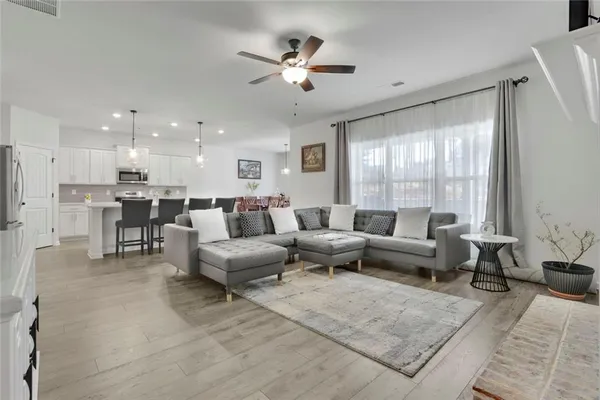 a living room with furniture and a large window