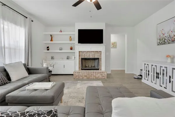 a living room with furniture a fireplace and a flat screen tv