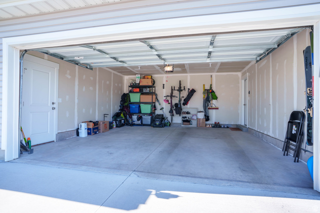 1486 West 2055th Street South Logan, UT 84339 - Photo 32 of 45 Spacious two-car garage featuring a clean concrete floor, light-colored walls, and an overhead garage door mechanism
