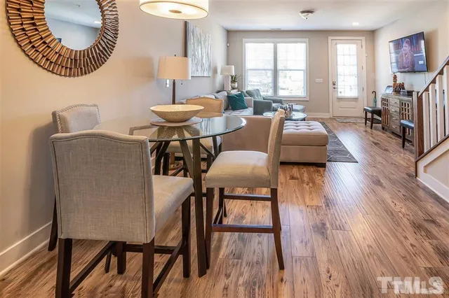 a living room with furniture a window and a wooden floor