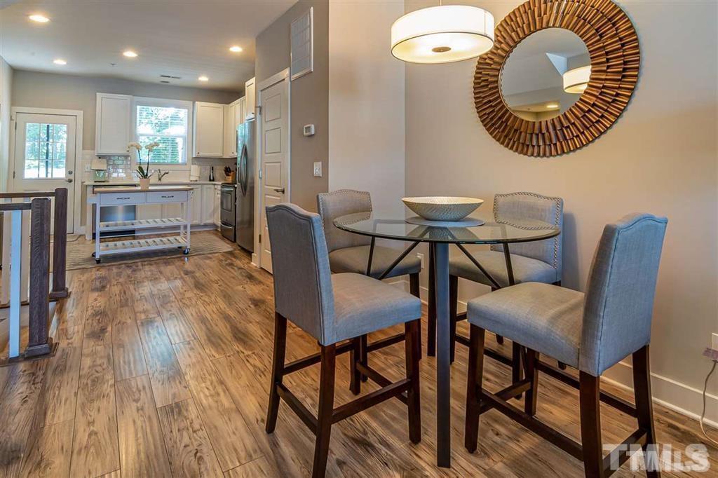 2800 Bedford Green Drive, Unit 106 Raleigh, NC 27604 - Photo 13 of 26 a view of a dining room with furniture and a large window