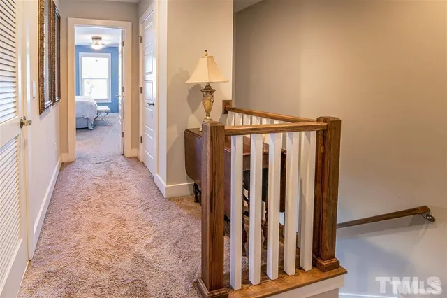 a view of a bedroom with wooden floor and stairs