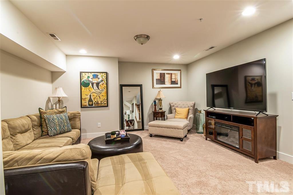 2800 Bedford Green Drive, Unit 106 Raleigh, NC 27604 - Photo 15 of 26 a living room with furniture and a flat screen tv