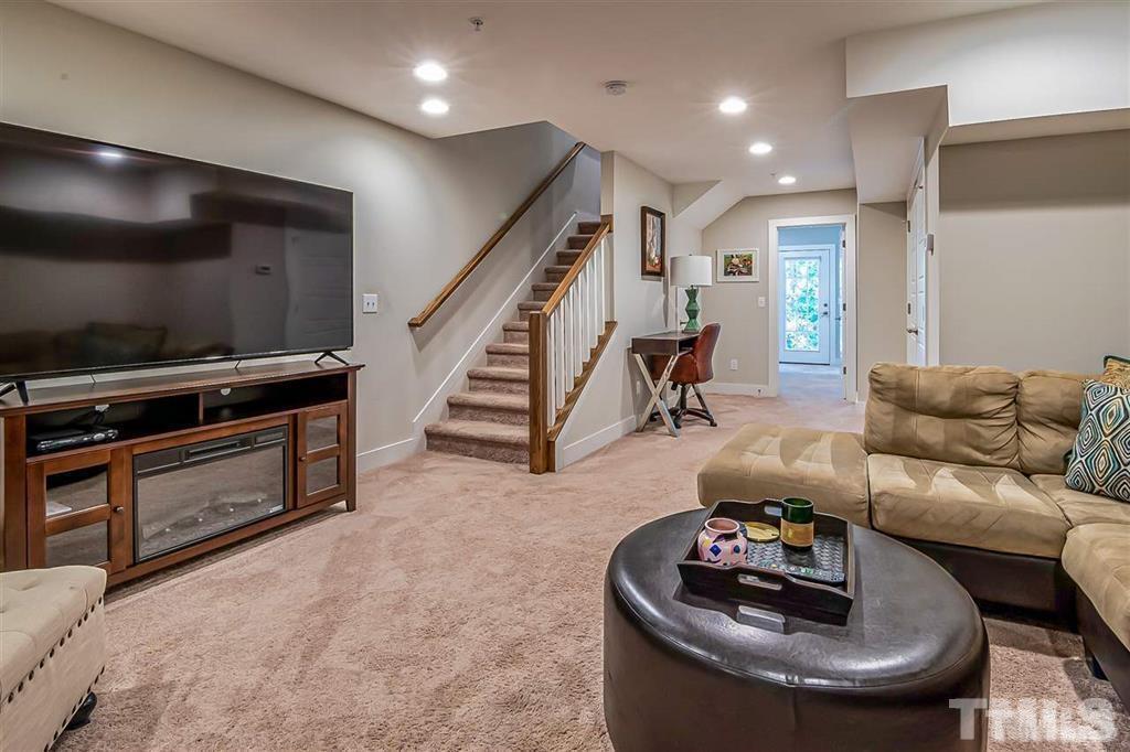 2800 Bedford Green Drive, Unit 106 Raleigh, NC 27604 - Photo 17 of 26 a living room with furniture and a flat screen tv