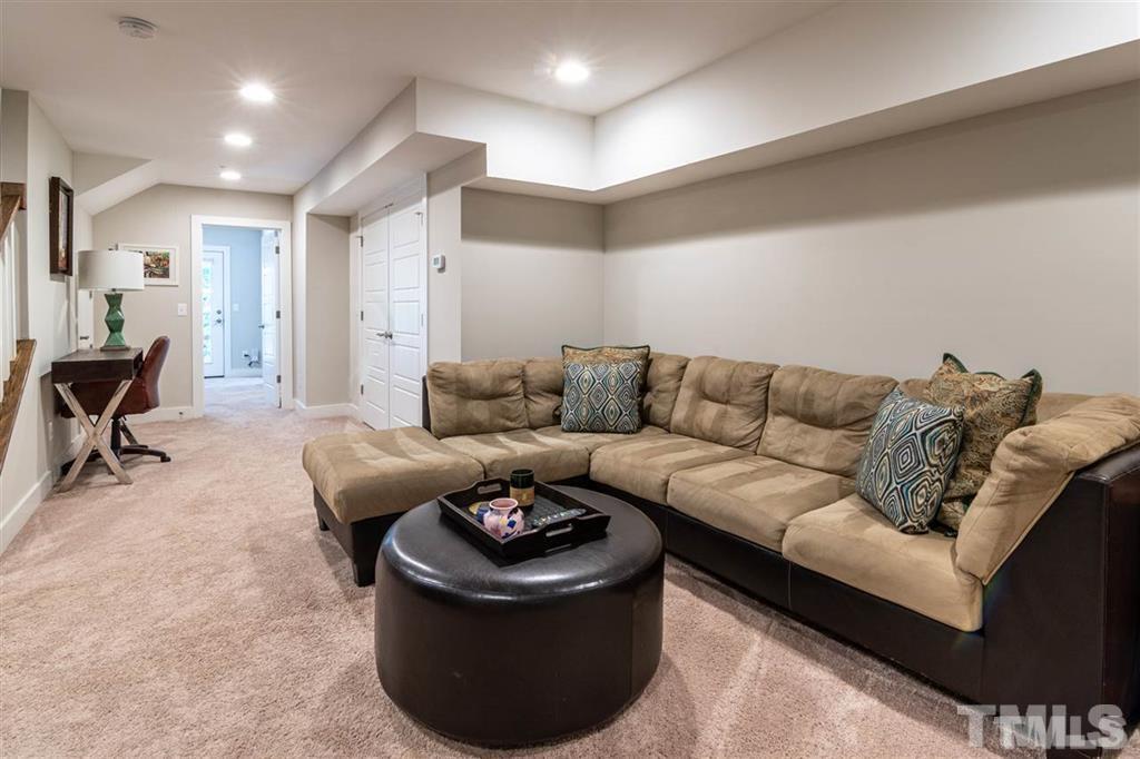 2800 Bedford Green Drive, Unit 106 Raleigh, NC 27604 - Photo 18 of 26 a living room with furniture and a couch