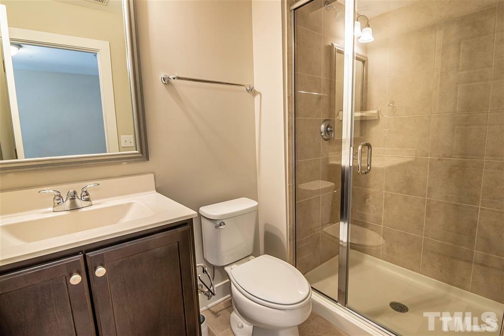 2800 Bedford Green Drive, Unit 106 Raleigh, NC 27604 - Photo 22 of 26 a bathroom with a sink a toilet and shower