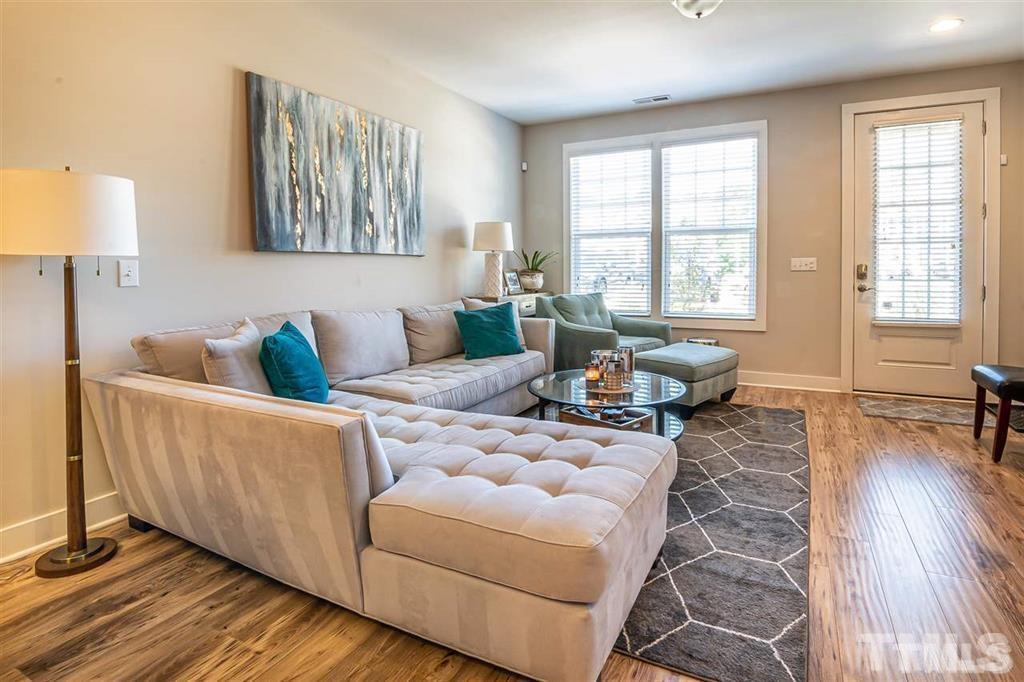 2800 Bedford Green Drive, Unit 106 Raleigh, NC 27604 - Photo 5 of 26 a living room with furniture and wooden floor