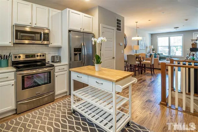 a kitchen with stainless steel appliances granite countertop a stove a sink dishwasher a microwave oven with granite countertops and cabinets