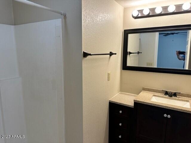 8020 East Thomas Road, Unit 214 Scottsdale, AZ 85251 - Photo 5 of 9 a bathroom with a sink and a mirror